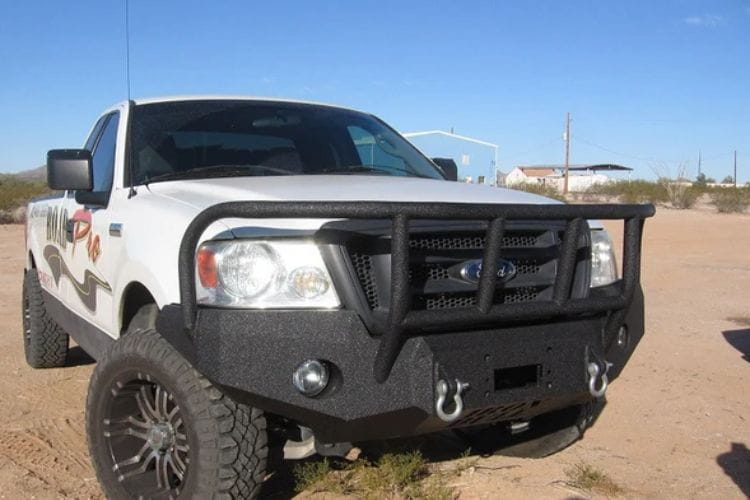 Heavy duty front bumper #21 by Iron Bull displays a black steel finish on a 2004-2008 Ford F150 rugged work truck 