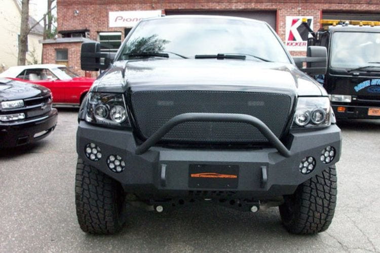 Heavy duty front bumper #21 by Iron Bull displays a black steel finish on a 2004-2008 Ford F150 rugged work truck 
