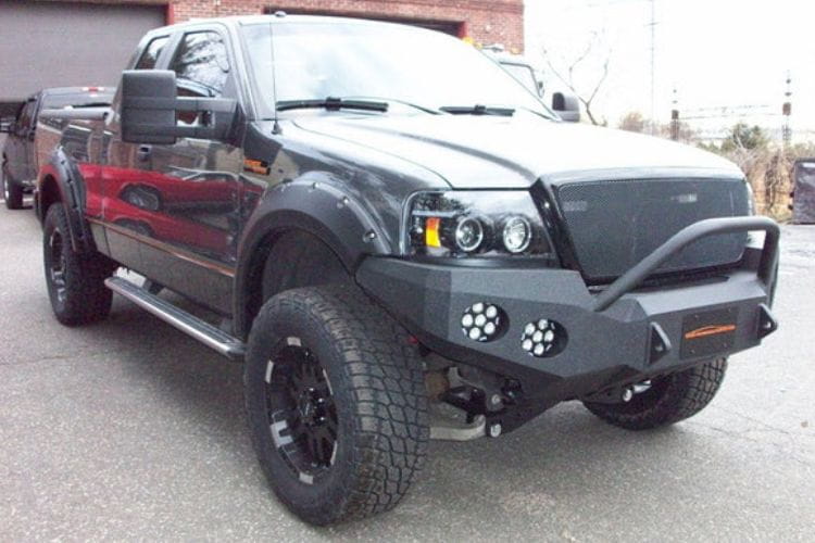 Heavy duty front bumper #21 by Iron Bull displays a black steel finish on a 2004-2008 Ford F150 rugged work truck 