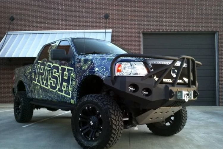 Heavy duty front bumper #21 by Iron Bull displays a black steel finish on a 2004-2008 Ford F150 rugged work truck 
