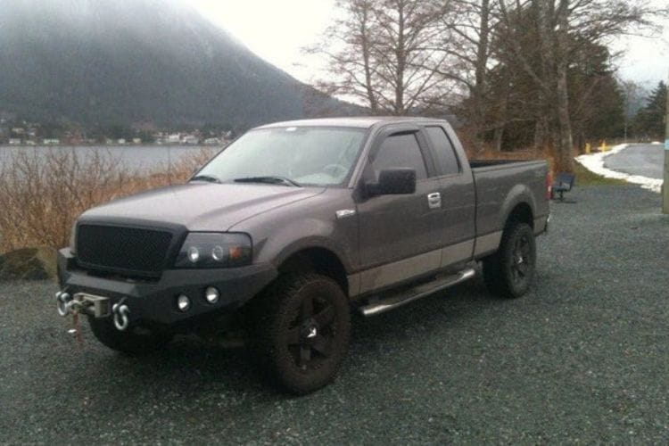 Heavy duty front bumper #21 by Iron Bull displays a black steel finish on a 2004-2008 Ford F150 rugged work truck 