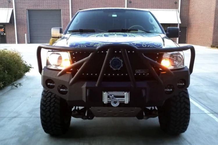 Heavy duty front bumper #21 by Iron Bull displays a black steel finish on a 2004-2008 Ford F150 rugged work truck 