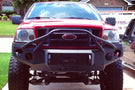 Heavy duty front bumper #21 by Iron Bull displays a black steel finish on a 2004-2008 Ford F150 rugged work truck 