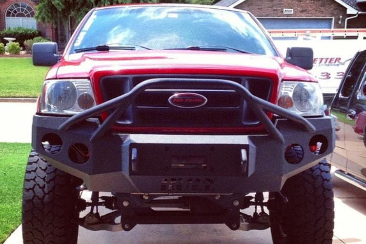 Heavy duty front bumper #21 by Iron Bull displays a black steel finish on a 2004-2008 Ford F150 rugged work truck 