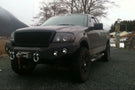 Heavy duty front bumper #21 by Iron Bull displays a black steel finish on a 2004-2008 Ford F150 rugged work truck 