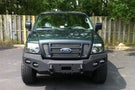 Heavy duty front bumper #21 by Iron Bull displays a black steel finish on a 2004-2008 Ford F150 rugged work truck 