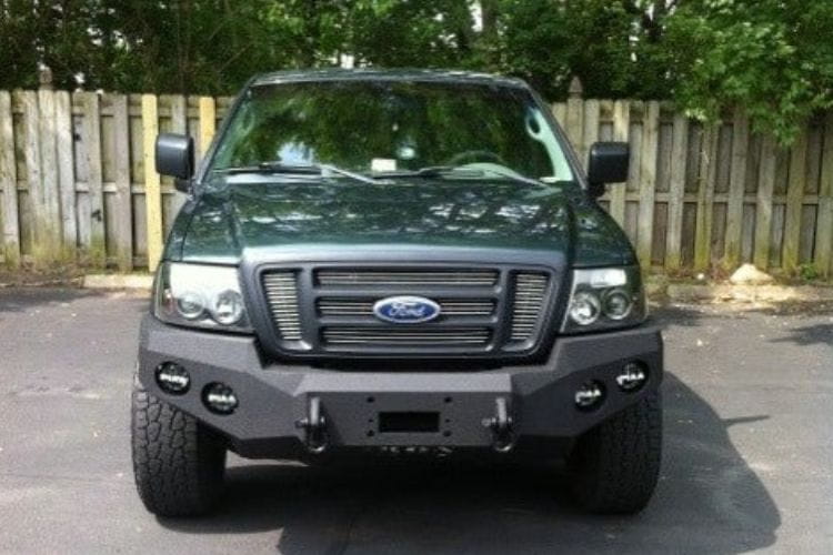 Heavy duty front bumper #21 by Iron Bull displays a black steel finish on a 2004-2008 Ford F150 rugged work truck 