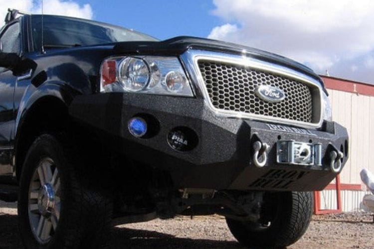 Heavy duty front bumper #21 by Iron Bull displays a black steel finish on a 2004-2008 Ford F150 rugged work truck 