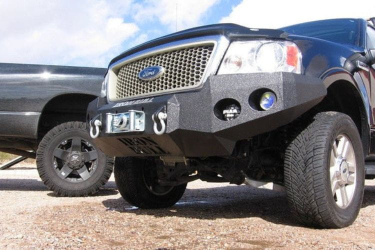 Heavy duty front bumper #21 by Iron Bull displays a black steel finish on a 2004-2008 Ford F150 rugged work truck 