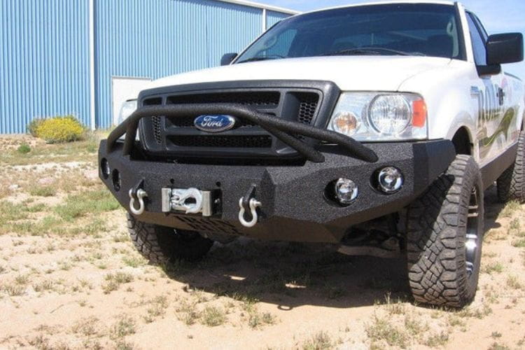 Heavy duty front bumper #21 by Iron Bull displays a black steel finish on a 2004-2008 Ford F150 rugged work truck 