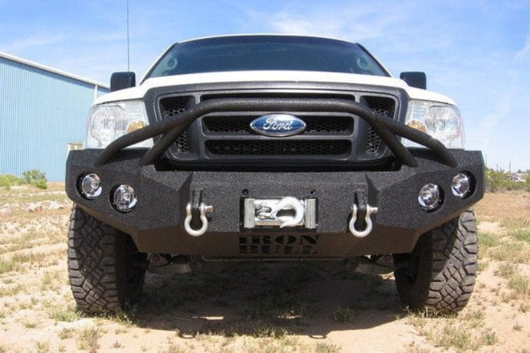 Heavy duty front bumper #21 by Iron Bull displays a black steel finish on a 2004-2008 Ford F150 rugged work truck 