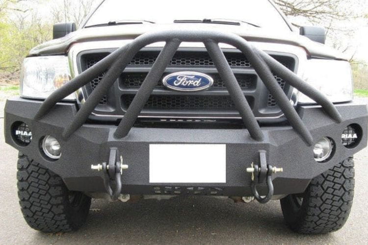 Heavy duty front bumper #21 by Iron Bull displays a black steel finish on a 2004-2008 Ford F150 rugged work truck 