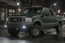 Night Raider Kit installed on a 2004 Ford F250 Super Duty built for the dark trails featuring Fab Fours front and rear bumpers and Rigid lights