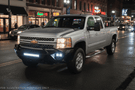 Night Raider Kit installed on a 2014 Silverado 2500HD to turn the truck into a night beast with heavy-duty Fab Fours bumpers and Rigid LED lighting