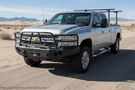 2014 Chevy Silverado 2500HD Overland Adventure Kit ready for off-road exploration with Hammerhead bumpers, Warn winch, TruXedo rack, and an ARB rooftop tent