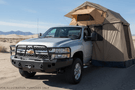 2014 Chevy Silverado 2500HD Overland Adventure Kit ready for off-road exploration with Hammerhead bumpers, Warn winch, TruXedo rack, and an ARB rooftop tent