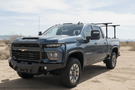 2025 Chevrolet Silverado 2500HD equipped with the Overland Adventure Kit, featuring Fab Fours front and rear bumpers, WARN VR EVO 12-S winch, TruXedo Elevate FS rack, and ARB rooftop tent for off-road adventure and cargo versatility