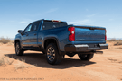 2025 Chevrolet Silverado 2500HD equipped with the Overland Adventure Kit, featuring Fab Fours front and rear bumpers, WARN VR EVO 12-S winch, TruXedo Elevate FS rack, and ARB rooftop tent for off-road adventure and cargo versatility