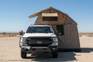 Overland Adventure Kit installed on a 2022 Ford F250 Superduty with Fab Fours bumpers, Warn winch, Truxedo rack and ARB roof tent built for any terrain.