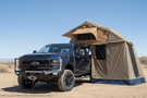2023 F250 Superduty Overland Adventure Kit featuring Fab Fours bumpers, Warn winch, Truxedo rack and ARB roof tent ready for off-road adventures.
