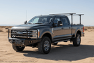 Overland Adventure Kit for a 2025 Ford F250, perfected for long-term durability with Warn & Road Armor bumpers, Warn winch, Truxedo rack and ARB rooftop tent.