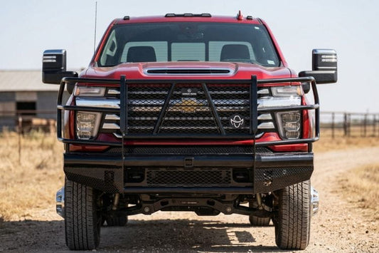 Front view of Ranch Hand FBC241BLR front bumper with grille guard for 2024–2026 Chevy Silverado 2500HD and 3500HD on a dirt road.