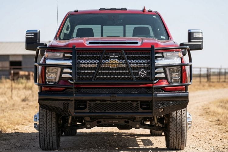 Front view of Ranch Hand FBC241BLR front bumper with grille guard for 2024–2026 Chevy Silverado 2500HD and 3500HD on a dirt road.