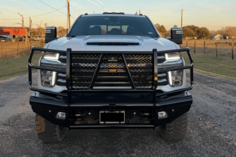 Front view of a white truck with Ranch Hand Legend Series Front Bumper in Black Matte for 2020-2023 Chevrolet Silverado 2500HD and 3500HD on a road.