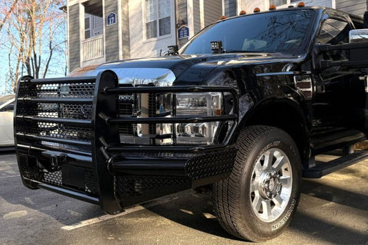 Ranch Hand Legend front bumper grille guard Ford F250 Superduty XLT 2008-2010 angled side view on a street with a building in the background