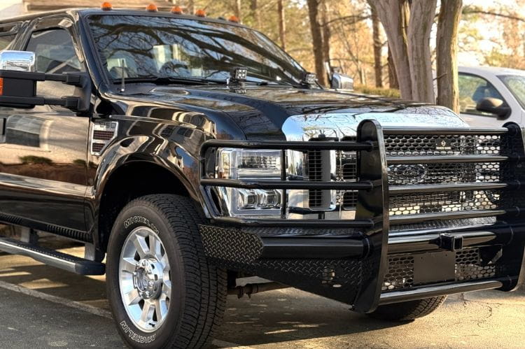 Ranch Hand Legend front bumper grille guard Ford F250 Superduty XLT 2008-2010 angled side view on a road
