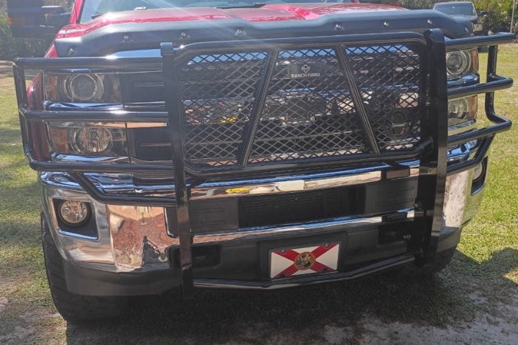 Ranch Hand Legend grille guard Chevy Silverado 2500HD 3500HD 2015-2019 front view on a grassy background