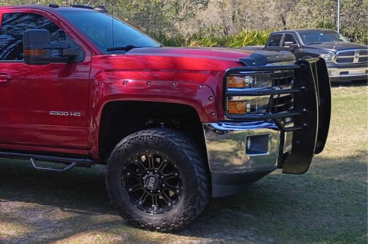 Ranch Hand Legend grille guard Chevy Silverado 2500HD 3500HD 2015-2019 front view on a grassy area