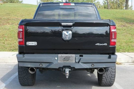 Black pickup truck Steelcraft Elevation Series Rear Bumper Replacement for 2019-2024 Dodge Ram 1500, flat black powder coat finish on a grassy area