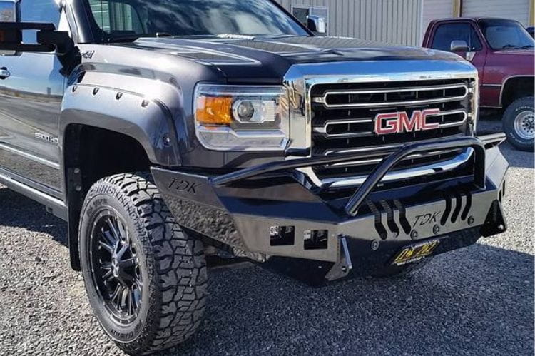 Throttle Down Kustoms Front Bumper with Pre-Runner Bar for 2015-2018 GMC Sierra 2500 and 3500, steel replacement bumper on a gravel surface