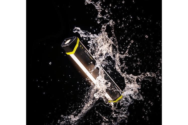 Portable flashlight with a black and yellow design being submerged in water