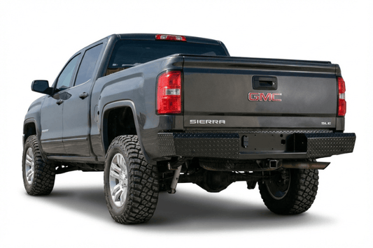 TrailFX FX1013 full replacement rear bumper for 2015-2019 GMC Sierra 2500 and 3500 HD, featuring a heavy-duty steel design with a textured black powder-coat finish.