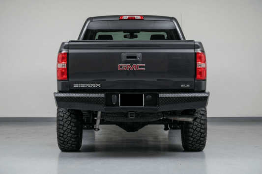 TrailFX FX1013 full replacement rear bumper for 2015-2019 GMC Sierra 2500 and 3500 HD, featuring a heavy-duty steel design with a textured black powder-coat finish.