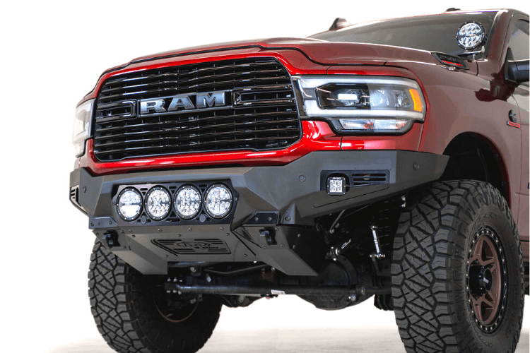 Front view of a red Ram truck featuring the ADD F560014110103 Bomber Black front bumper for Dodge Ram 2500/3500 models