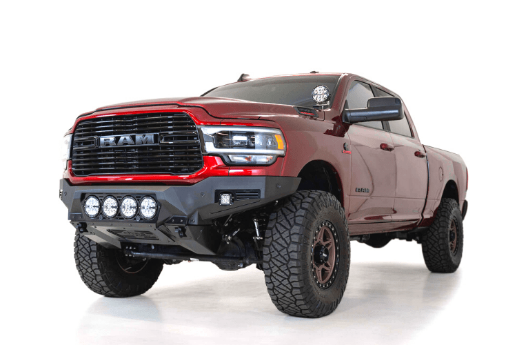 Front view of a red Ram truck featuring the ADD F560014110103 Bomber Black front bumper for Dodge Ram 2500/3500 models