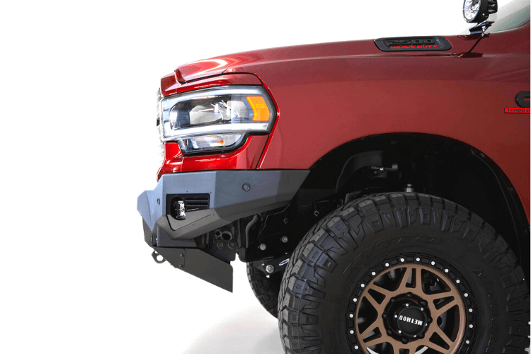 Front view of a red Ram truck featuring the ADD F560014110103 Bomber Black front bumper for Dodge Ram 2500/3500 models