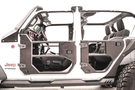 Open doors of a Jeep Wrangler JL 2018-2024, showcasing the Fab Fours JL1032-1 Half Front Tube Door design