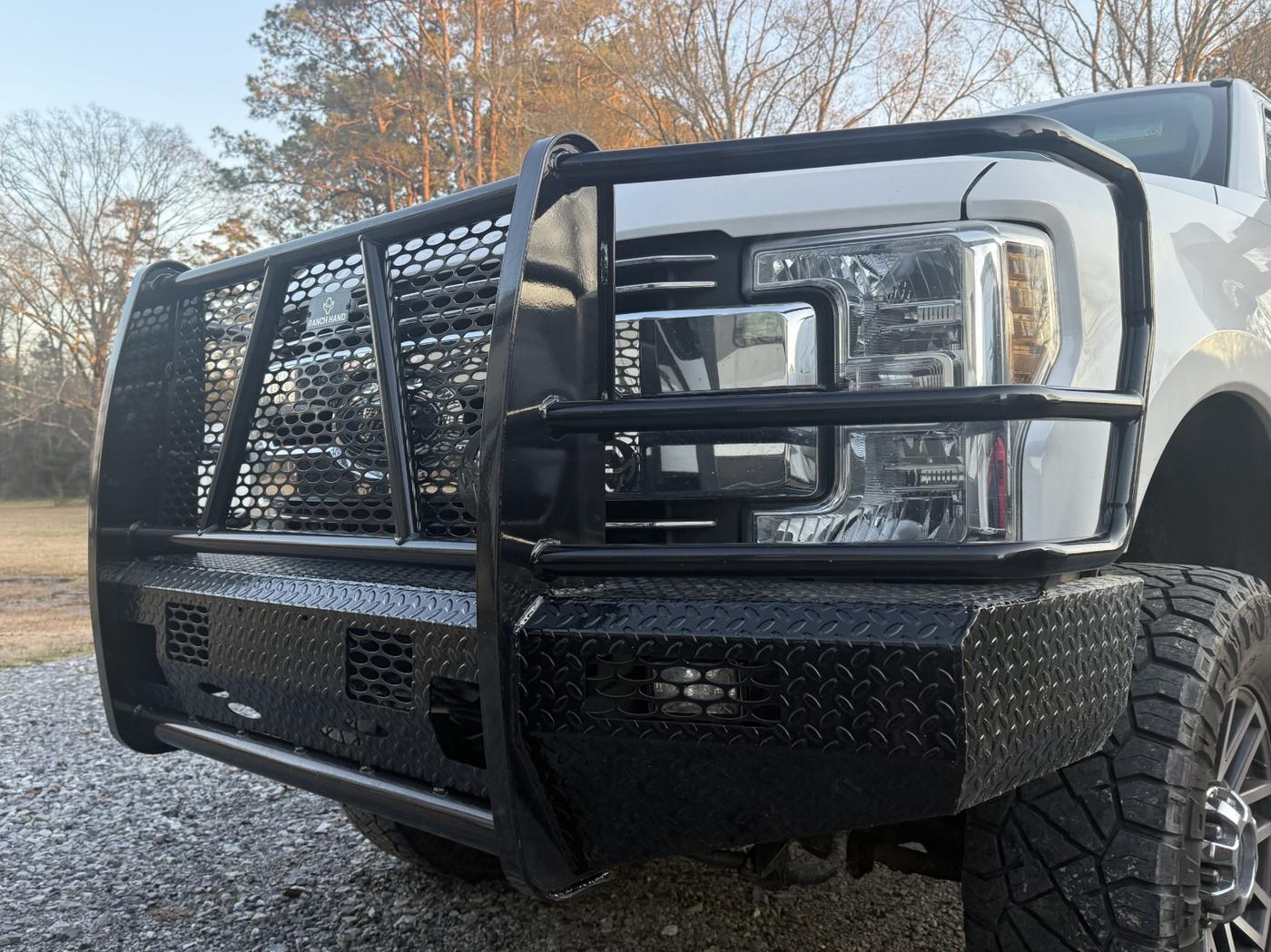 Close-up of a Ranch Hand Summit front bumper on a white Ford Super Duty